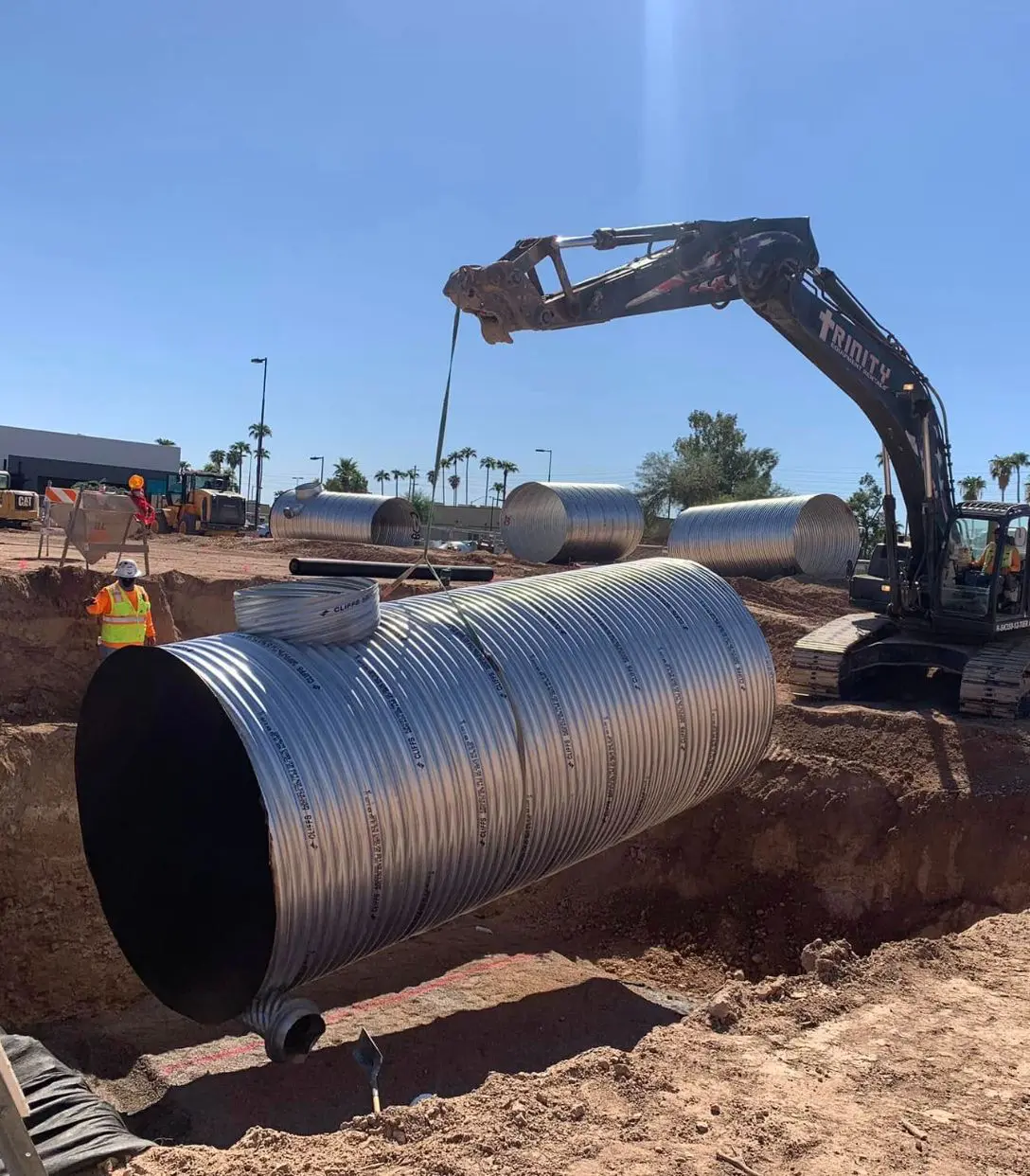 469326537_1304539084294963_540319575096565313_ (1) A large pipe being installed in the ground.